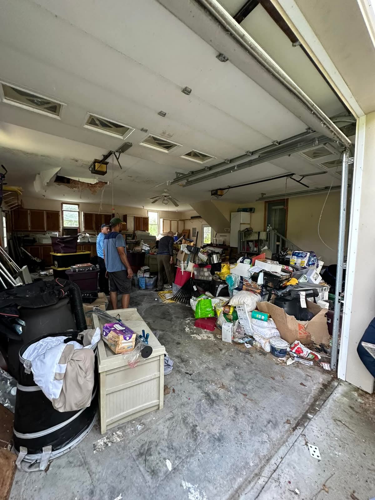 Express Waste Removal crew hauling junk out of a packed garage